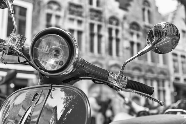 old,fashioned,scooter,in,city,center,,black,and,white,view.